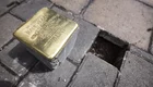 Ein Stolperstein aus Bronze mit der Inschrift zu Ehren von Karl W. Heimer. Er gehört zu einer Gedenkaktion für Opfer des Nationalsozialismus. Der Stein liegt auf dem Gehweg, umgeben von Pflastersteinen und einem leeren Platz, wo ein weiterer Stein platziert werden könnte.